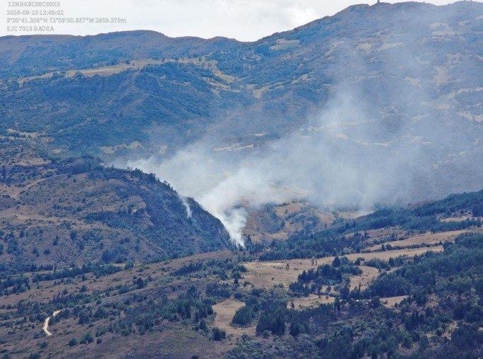 Vista panorámica del incendio forestal en la vereda Toledo, donde se observa una columna de humo elevándose desde la ladera y extendiéndose sobre la zona rural.